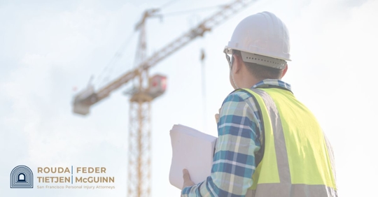 construction worker looking at a crane